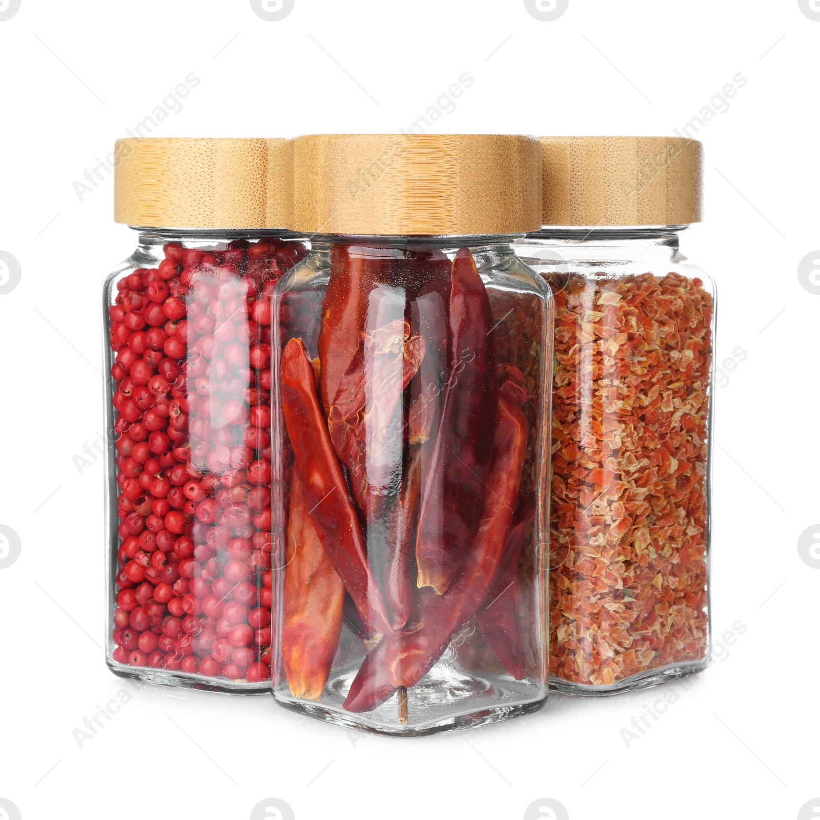 Photo of Different aromatic spices in glass jars isolated on white