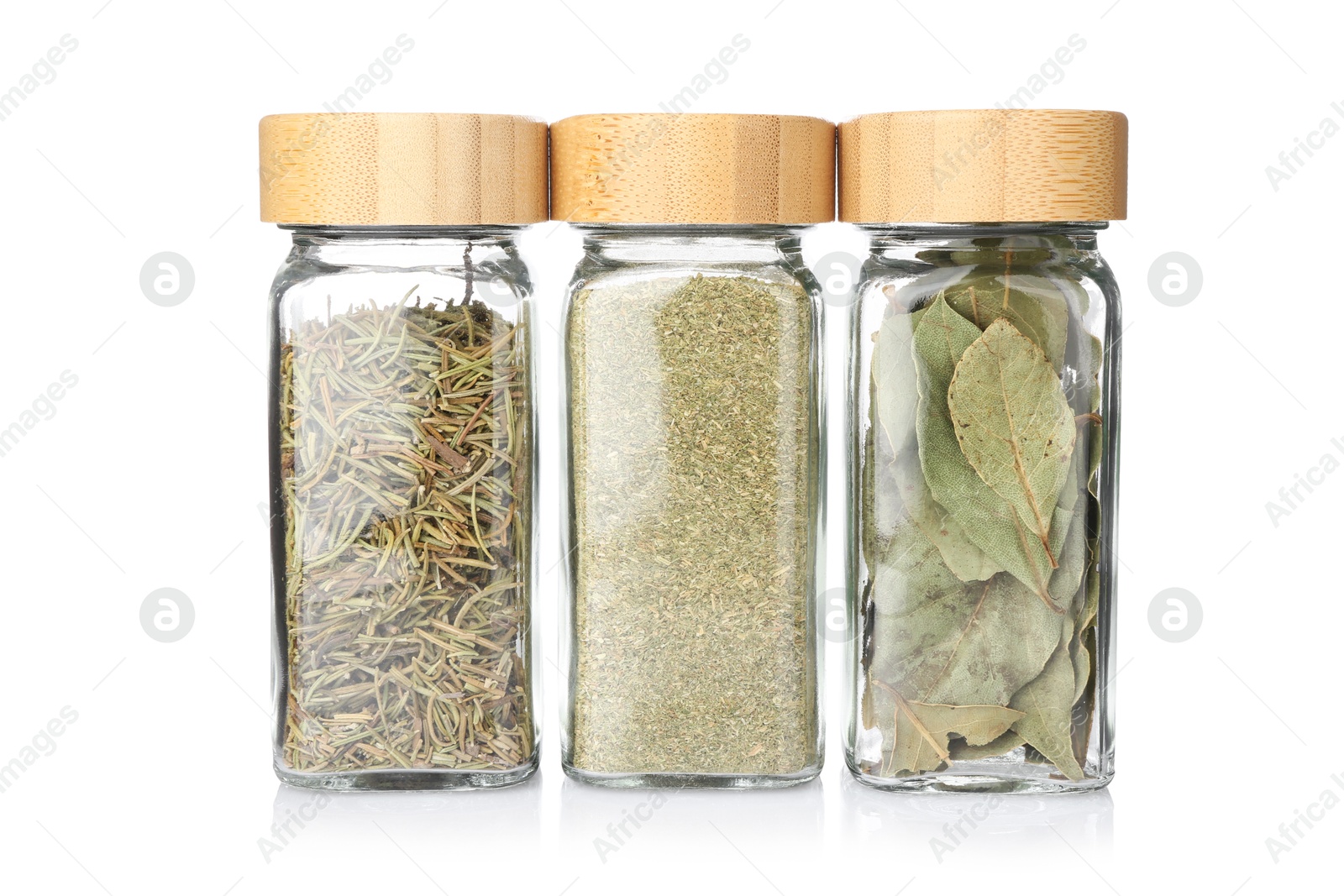 Photo of Different aromatic spices in glass jars isolated on white