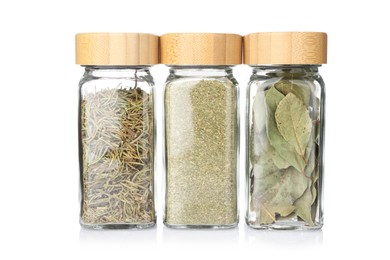 Photo of Different aromatic spices in glass jars isolated on white