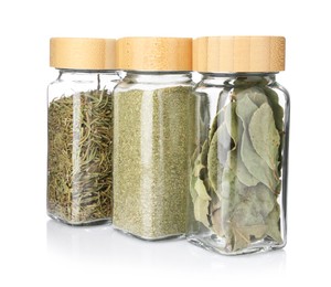 Photo of Different aromatic spices in glass jars isolated on white