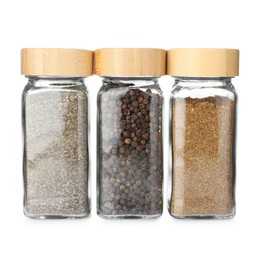 Photo of Different aromatic spices in glass jars isolated on white