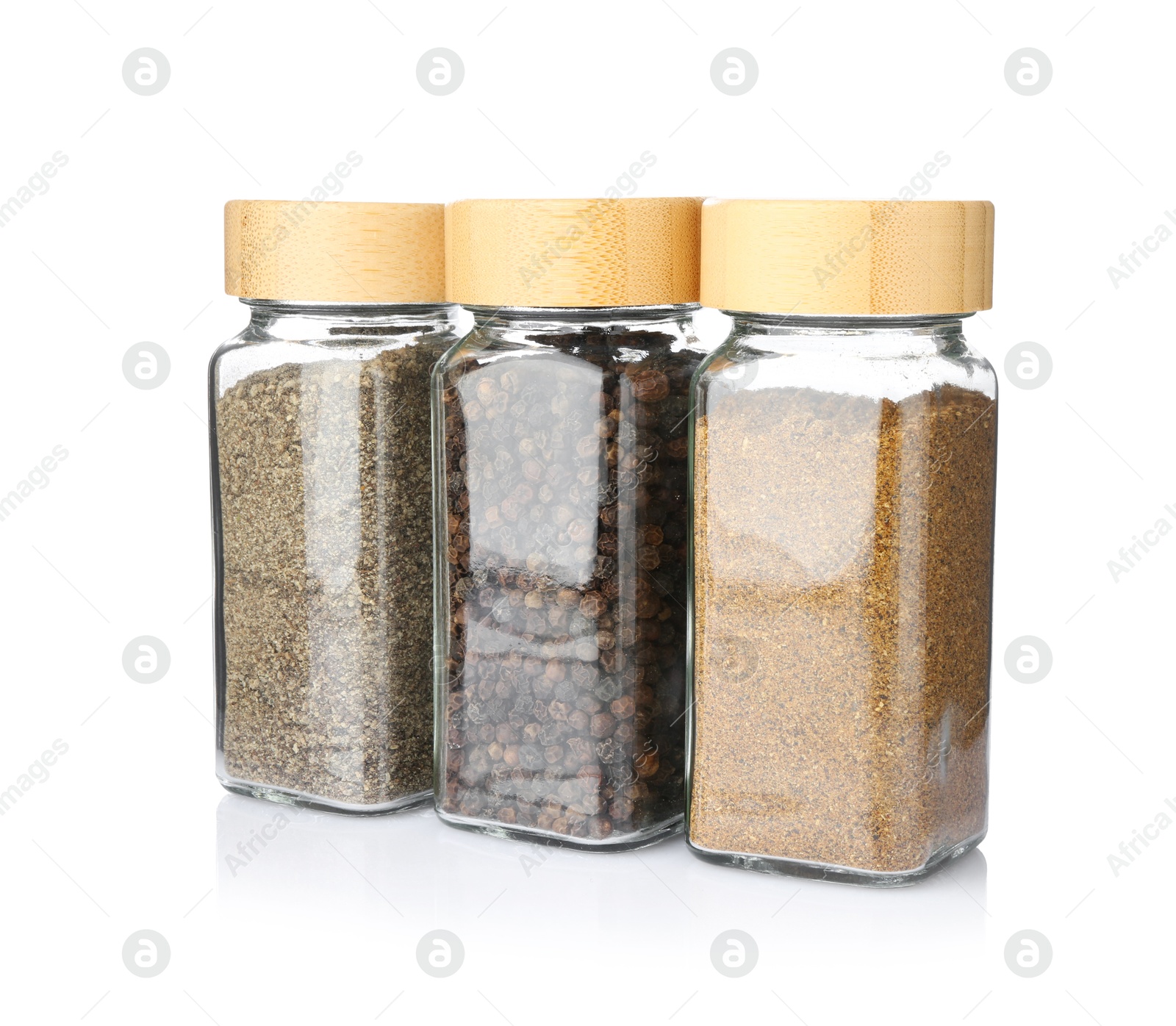 Photo of Different aromatic spices in glass jars isolated on white