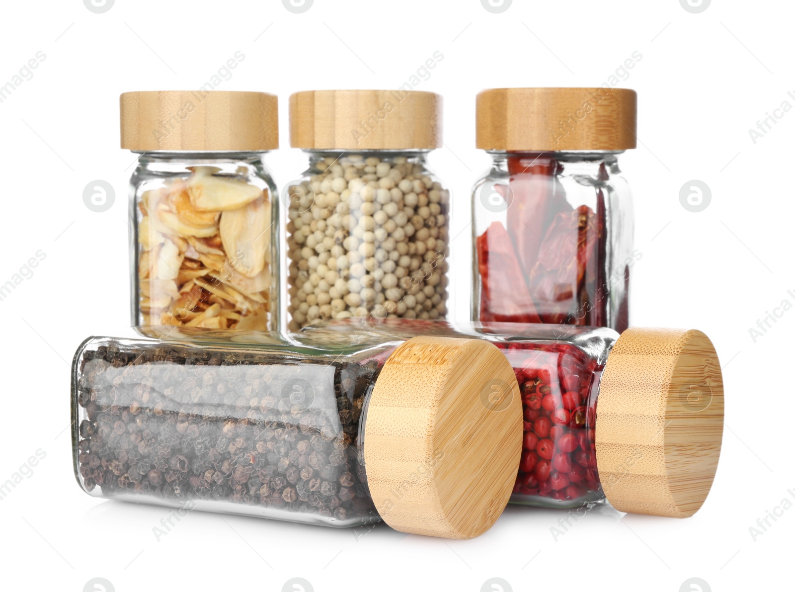 Different aromatic spices in glass jars isolated on white Photo of Different aromatic spices in glass jars isolated on white