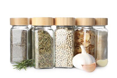 Photo of Many different aromatic spices in jars isolated on white