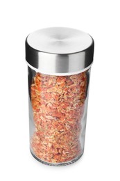 Photo of Dried carrot flakes in spice jar isolated on white