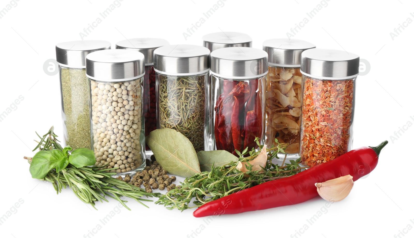 Photo of Many different aromatic spices in jars isolated on white