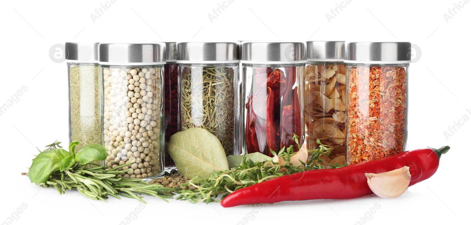 Photo of Many different aromatic spices in jars isolated on white