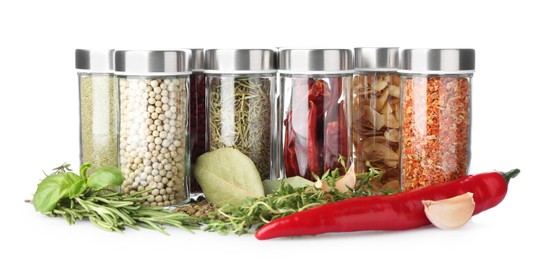 Photo of Many different aromatic spices in jars isolated on white