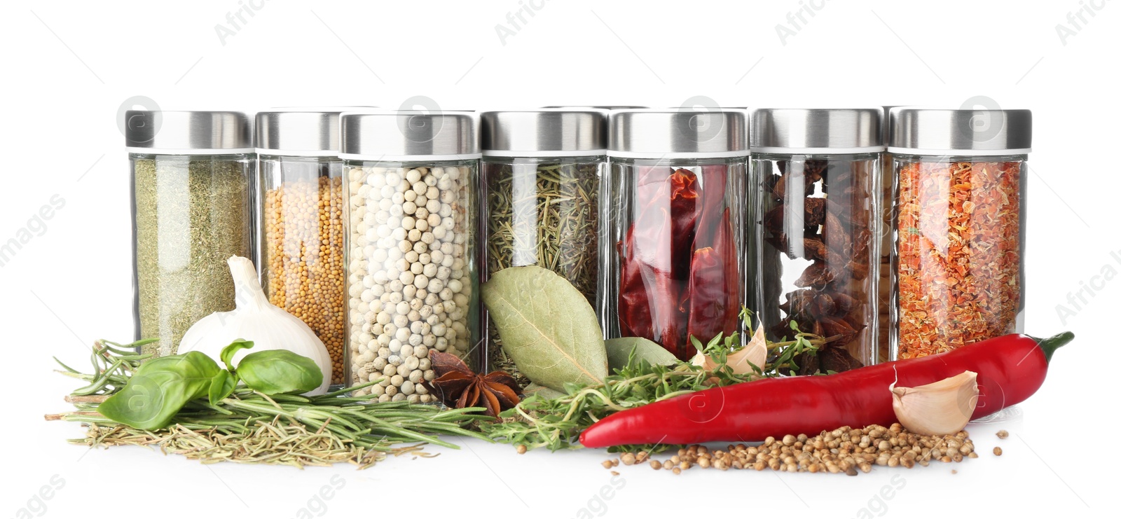 Photo of Many different aromatic spices in jars isolated on white