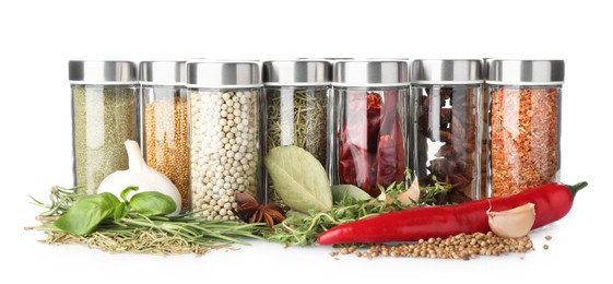 Photo of Many different aromatic spices in jars isolated on white