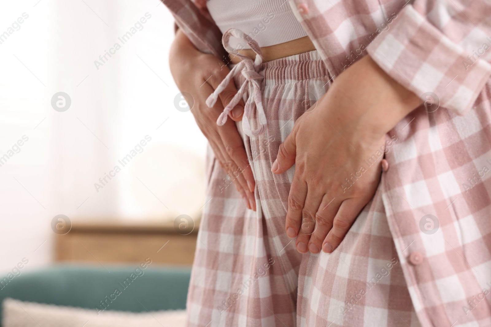 Photo of Woman suffering from cystitis symptoms at home, closeup. Space for text