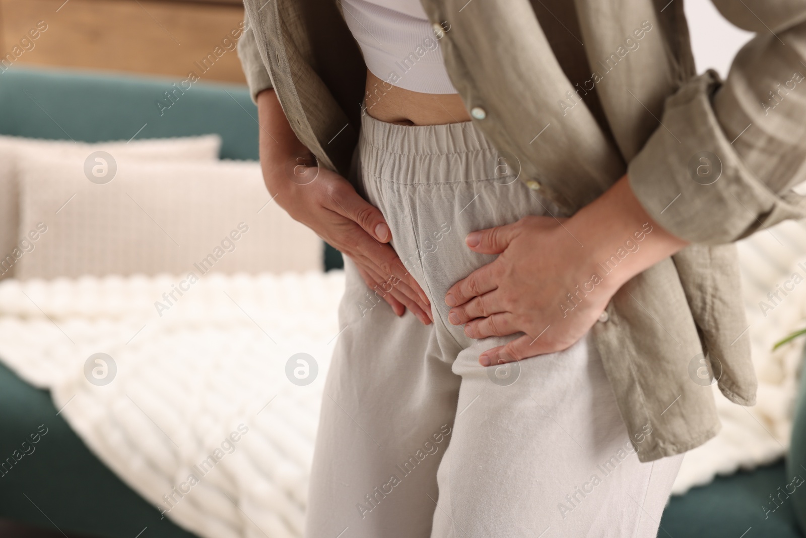 Photo of Woman suffering from cystitis symptoms at home, closeup. Space for text