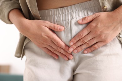 Photo of Woman suffering from cystitis symptoms at home, closeup