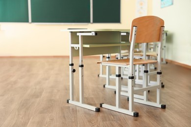 Photo of Desks with chairs in classroom. Back to school