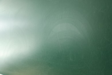 Photo of Blank green chalkboard as background, closeup view