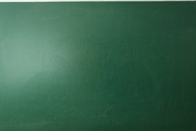 Photo of Blank green chalkboard as background, closeup view