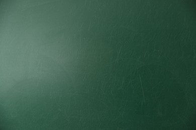 Photo of Blank green chalkboard as background, closeup view