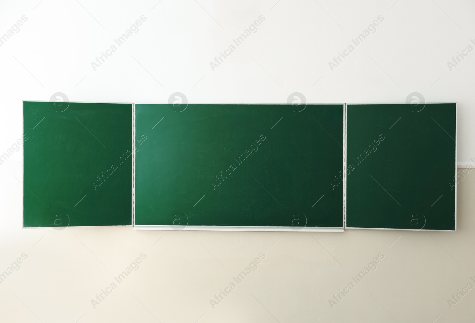 Photo of Green chalkboard on wall in classroom. Back to school