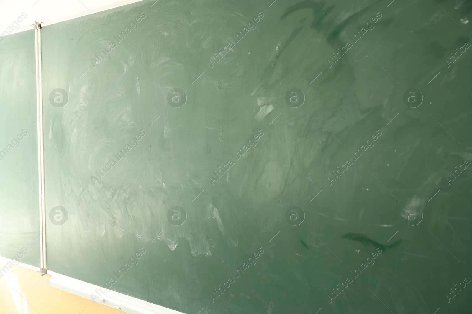 Photo of Green chalkboard on wall in classroom, closeup