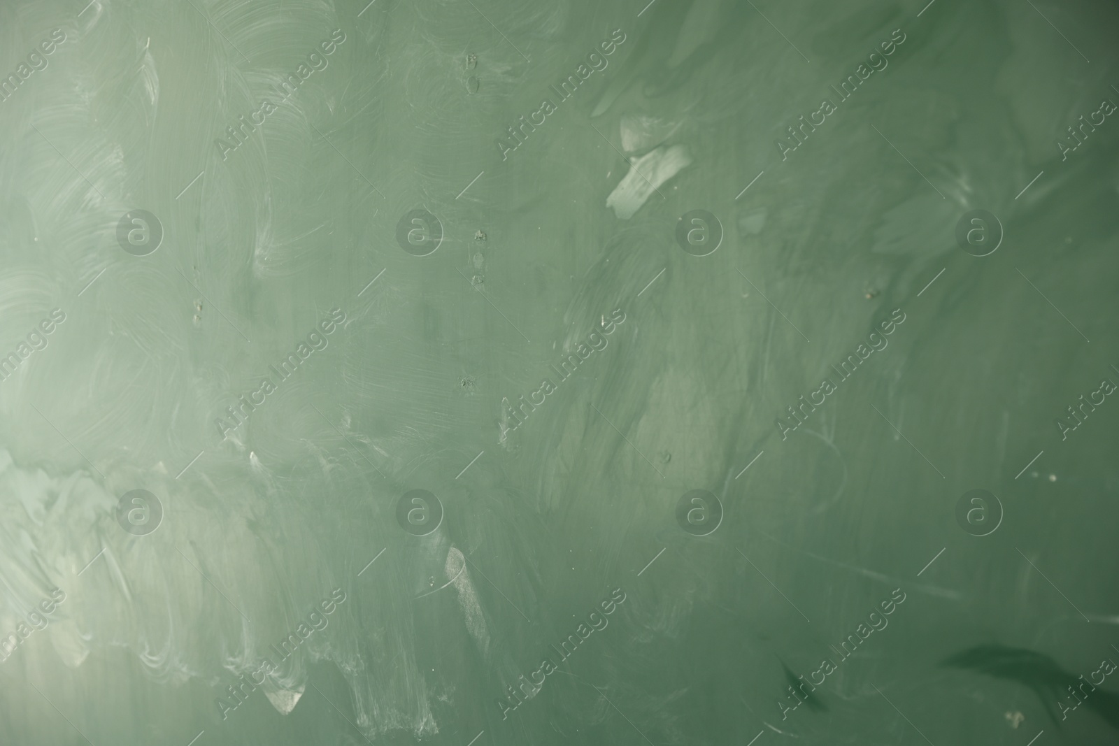 Photo of Blank green chalkboard as background, closeup view