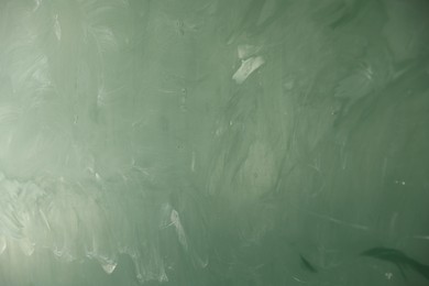 Photo of Blank green chalkboard as background, closeup view