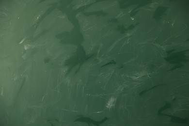 Photo of Blank green chalkboard as background, closeup view