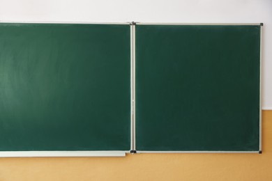 Photo of Green chalkboard on wall in classroom, closeup