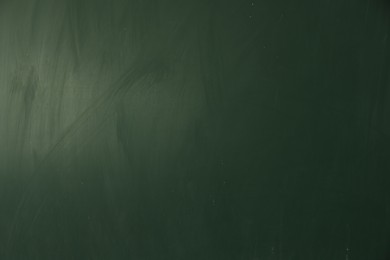 Photo of Blank green chalkboard as background, closeup view