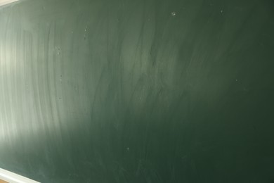 Photo of Blank green chalkboard as background, closeup view