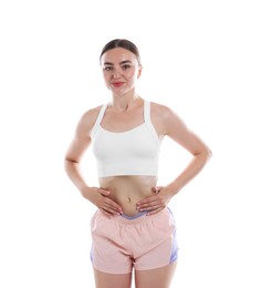 Photo of Woman doing abdominal vacuum exercise on white background