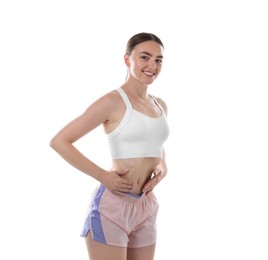 Photo of Happy woman doing abdominal vacuum exercise on white background