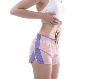 Photo of Woman doing abdominal vacuum exercise on white background, closeup