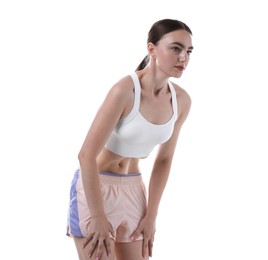 Photo of Woman doing abdominal vacuum exercise on white background