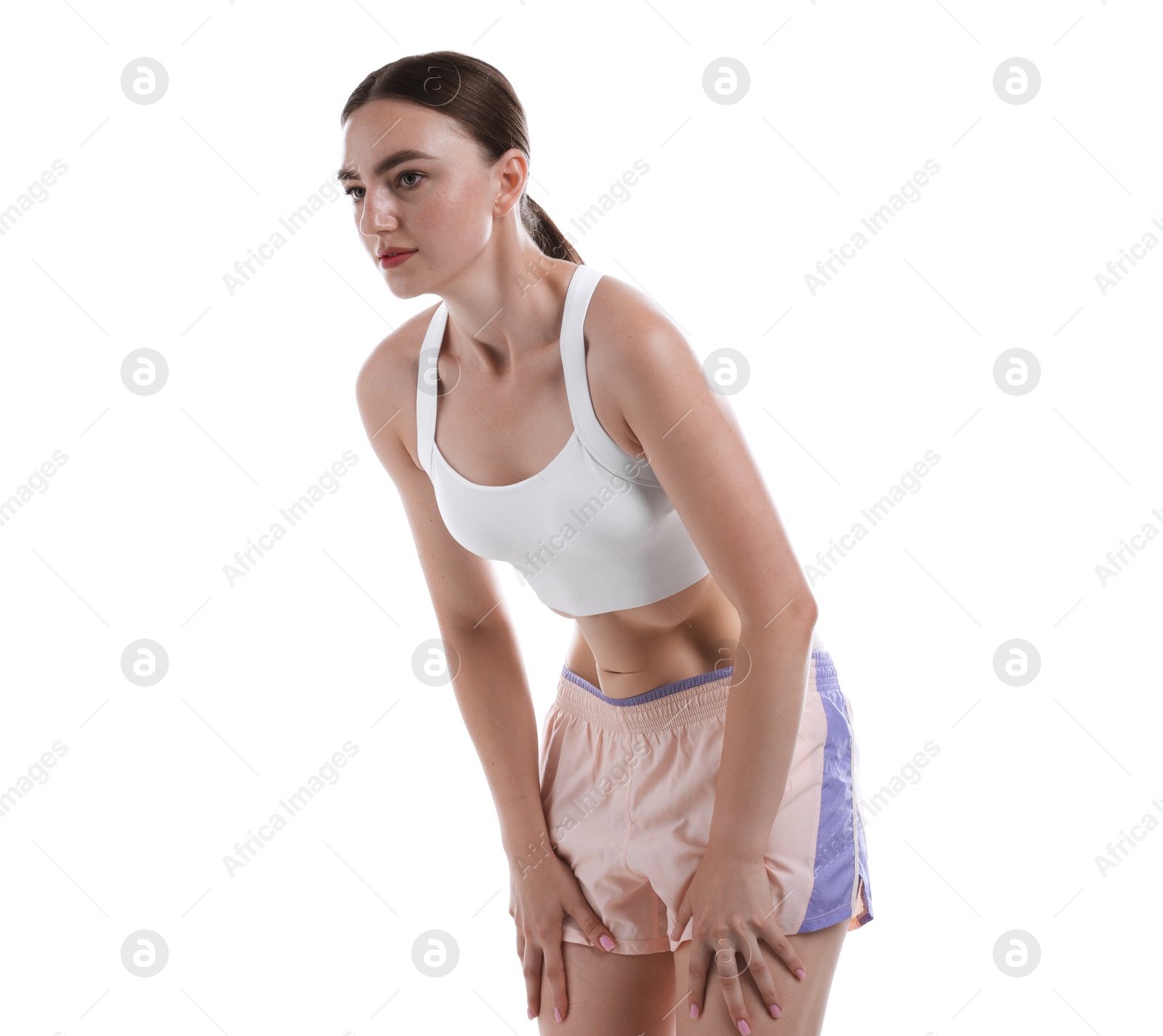 Photo of Woman doing abdominal vacuum exercise on white background