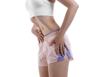 Photo of Woman doing abdominal vacuum exercise on white background, closeup