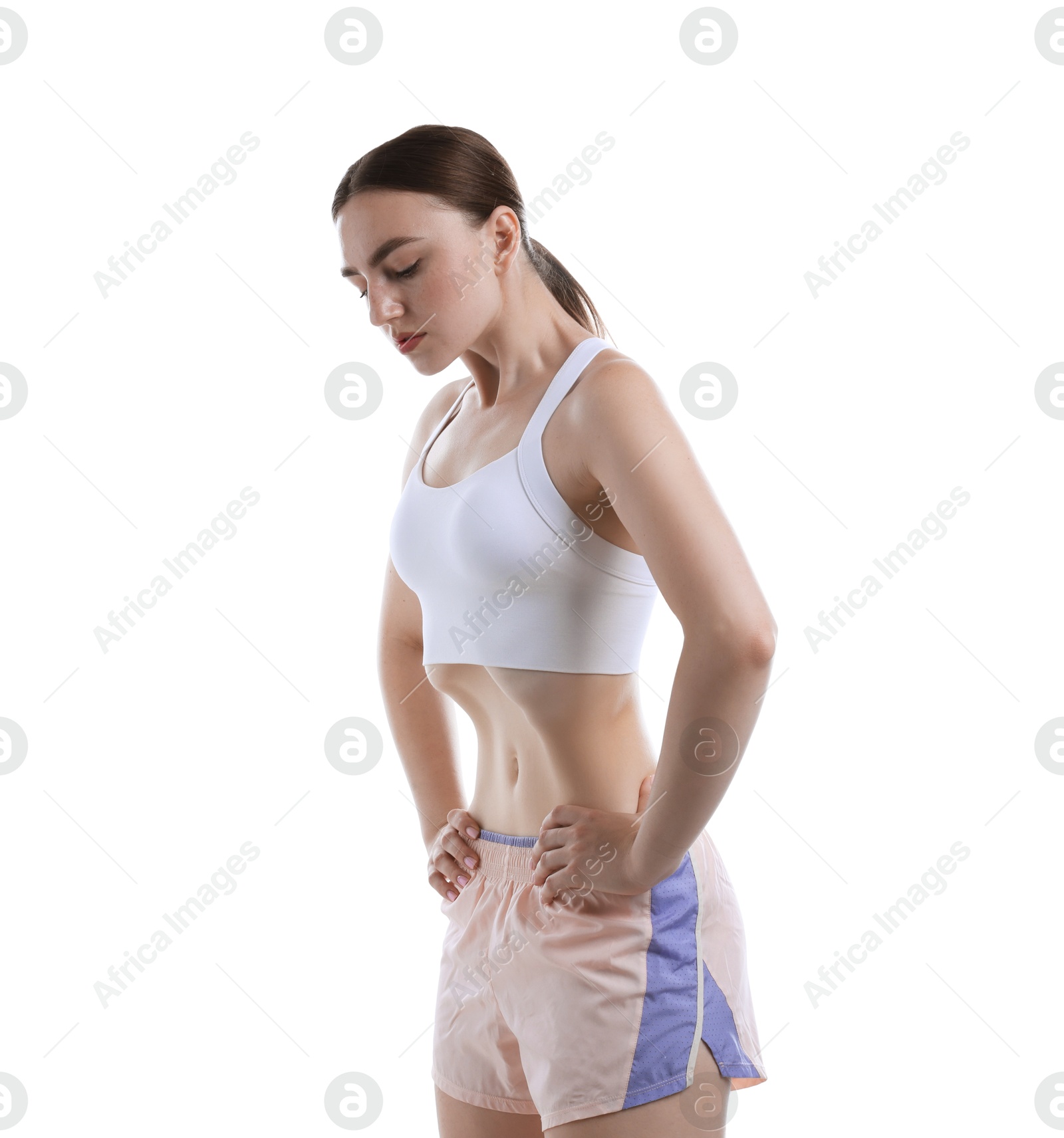 Woman doing abdominal vacuum exercise on white background Photo of Woman doing abdominal vacuum exercise on white background