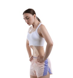 Photo of Woman doing abdominal vacuum exercise on white background