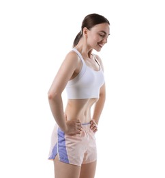 Photo of Happy woman doing abdominal vacuum exercise on white background