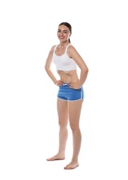 Photo of Happy woman doing abdominal vacuum exercise on white background
