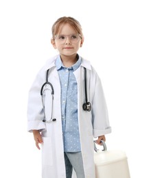 Photo of Choice of profession. Little girl in uniform with stethoscope and case pretending to be doctor on white background