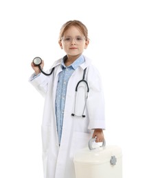 Photo of Choice of profession. Little girl in uniform with stethoscope and case pretending to be doctor on white background
