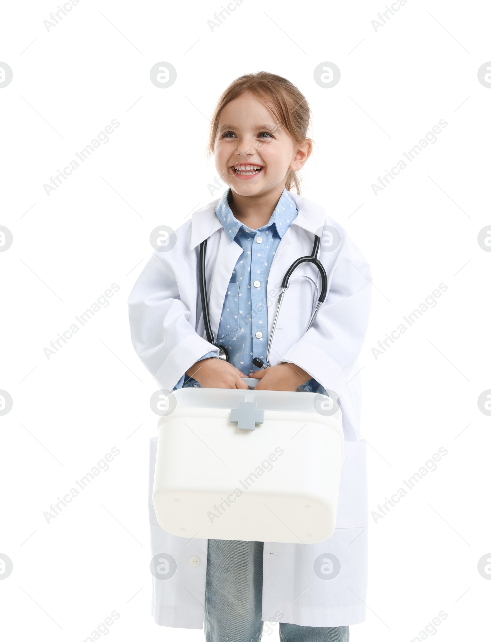 Photo of Choice of profession. Little girl in uniform with stethoscope and case pretending to be doctor on white background