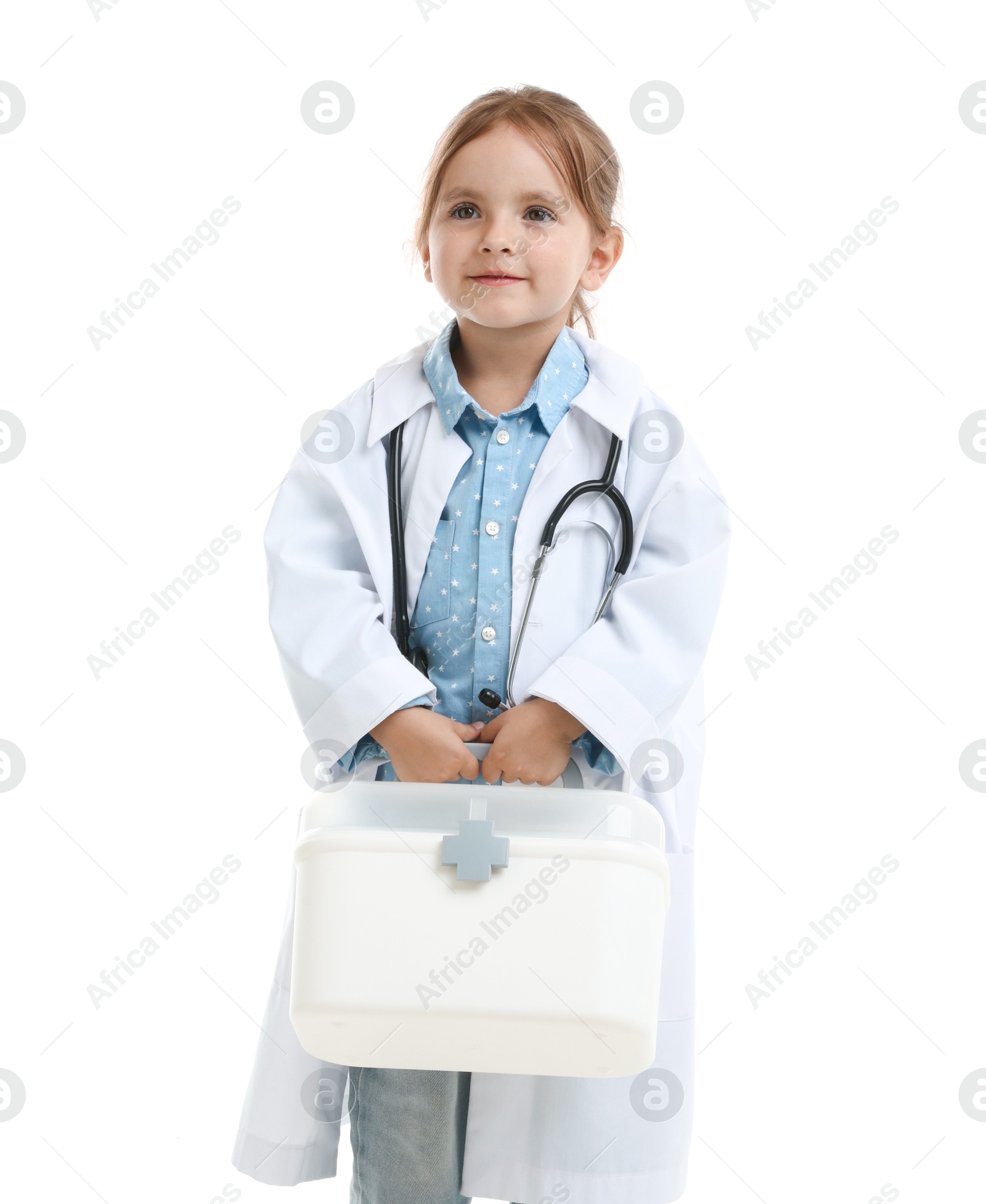Photo of Choice of profession. Little girl in uniform with stethoscope and case pretending to be doctor on white background