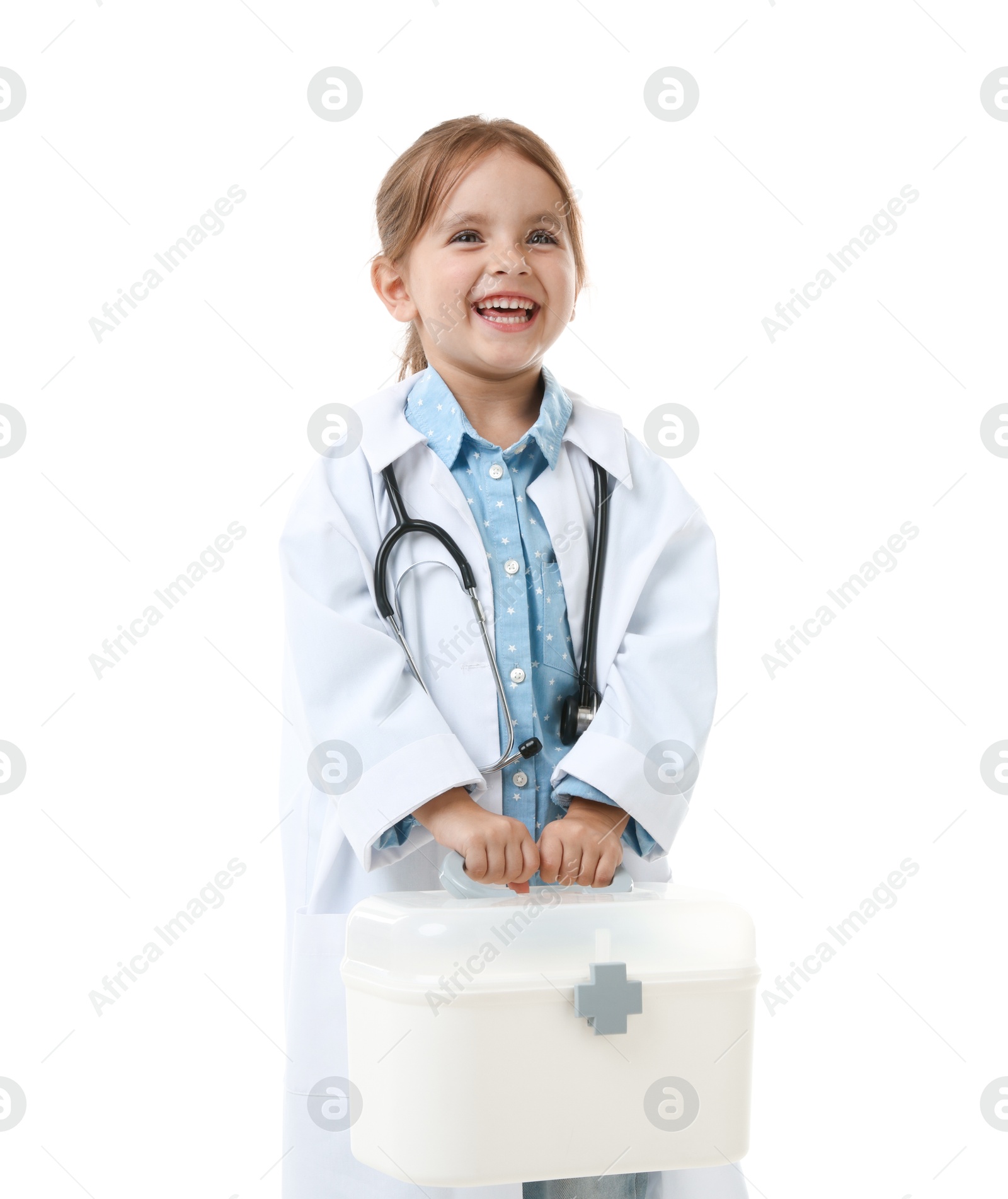 Photo of Choice of profession. Little girl in uniform with stethoscope and case pretending to be doctor on white background