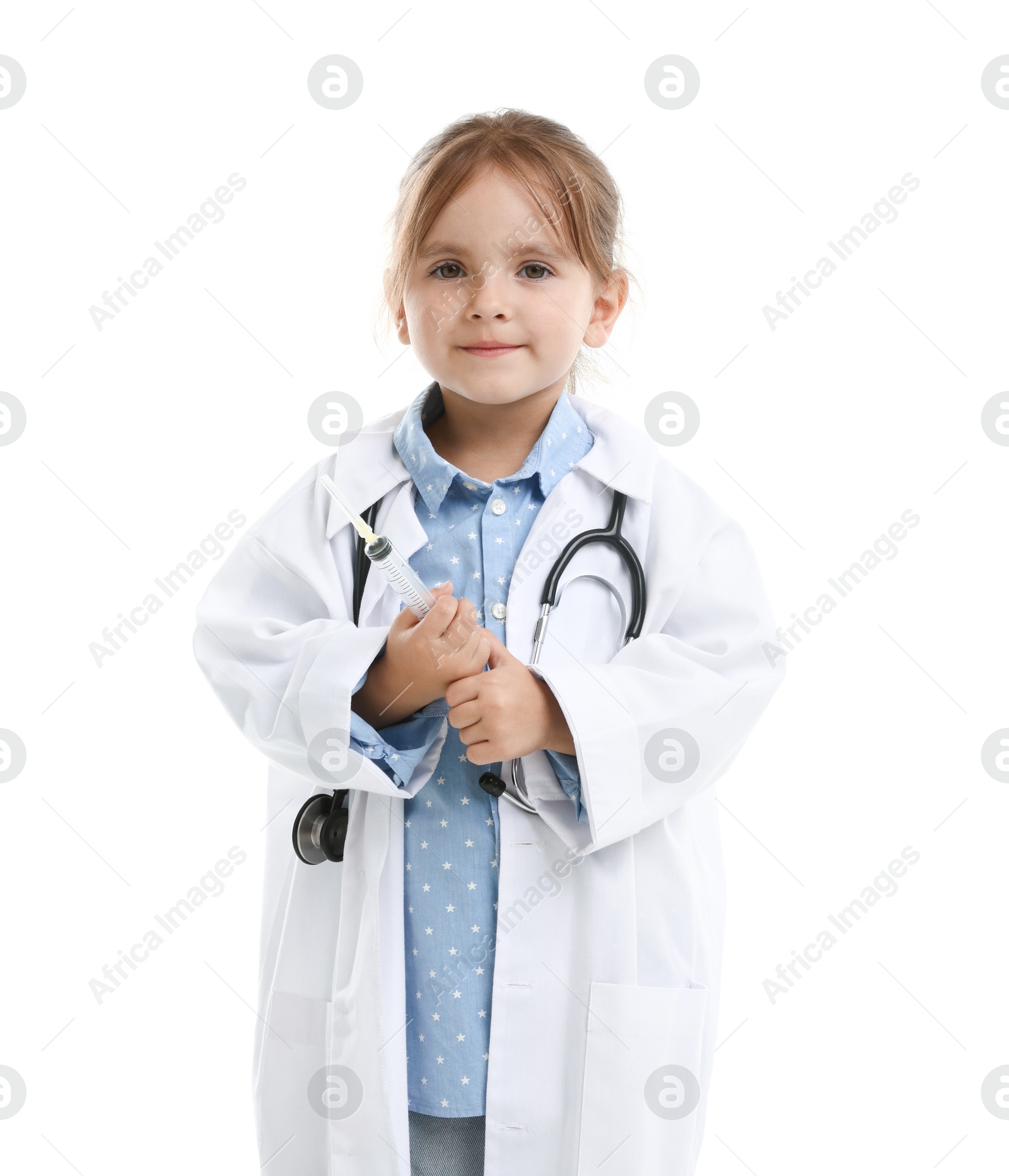Photo of Choice of profession. Little girl in uniform with stethoscope and syringe pretending to be doctor on white background