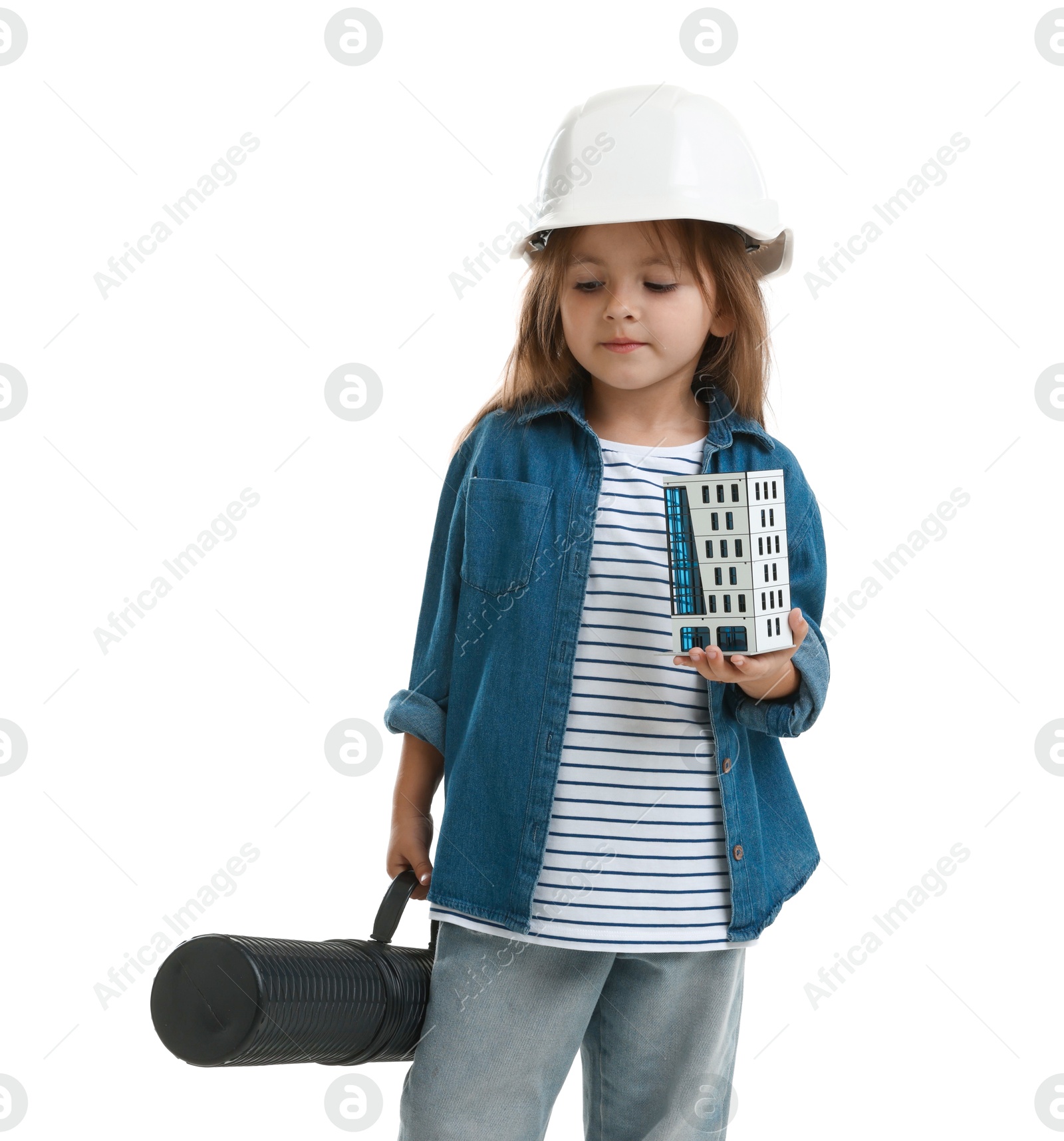 Photo of Choice of profession. Little girl in hardhat with building model and drawing tube pretending to be architect on white background