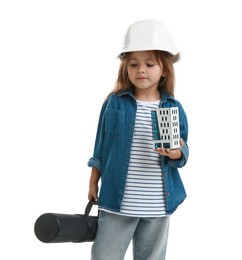 Photo of Choice of profession. Little girl in hardhat with building model and drawing tube pretending to be architect on white background