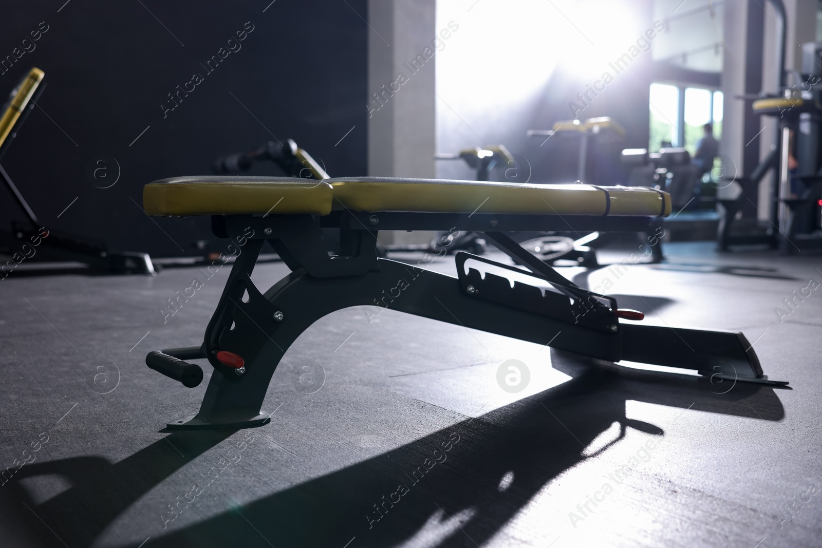 Photo of Exercise bench on floor in gym. Sport equipment