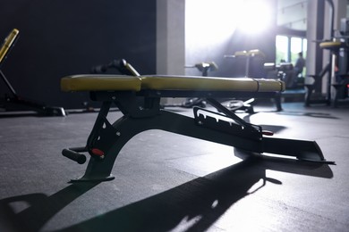 Photo of Exercise bench on floor in gym. Sport equipment