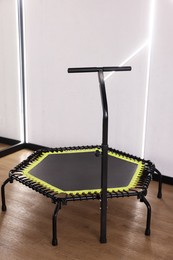 Photo of Mini exercise trampoline near white wall in fitness studio